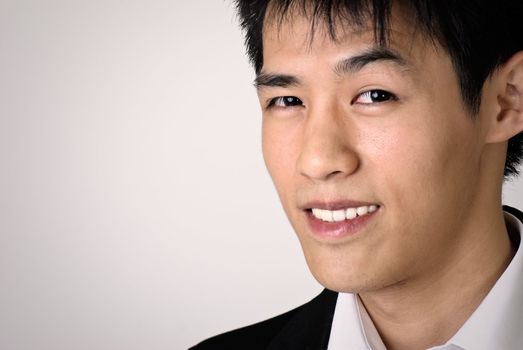 Closeup portrait of smiling business man of Asian with copyspace.