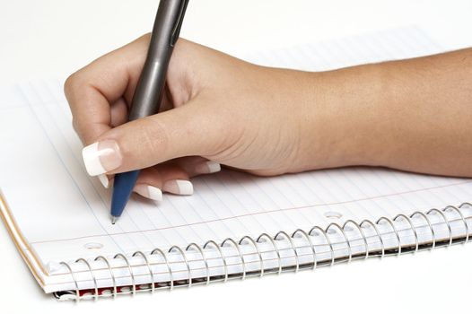 a macro picture of a female hand holding a pen