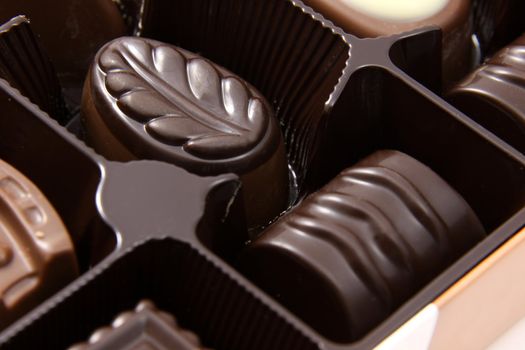 A closeup of a box of chocolate truffles.