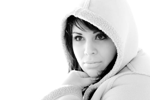 A young hispanic woman with a hood on her head in black and white.