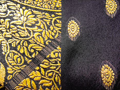 A closeup of a yellow and grey tradiational indian fabric, known as the sari/saree. makes a nice background