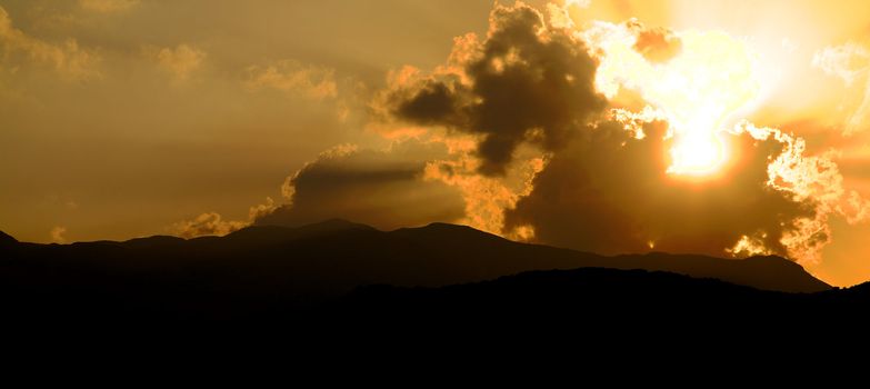 Dramatic sunset over the hills in the mist