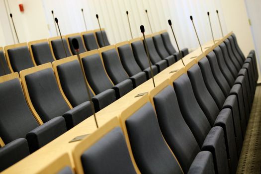 Detail of interior of court room with seats and microphones