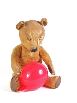 1950 teddy bear with a red balloon.