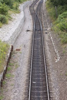 A single piece of railway track with a switch over section, located at Harmans Cross station, part of the Swanage Steam Railway system in Dorset.