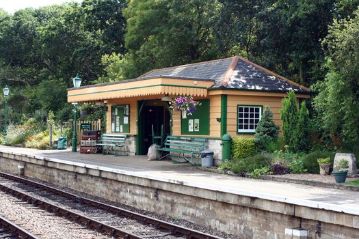 The station platform and waiting room at Harmans Cross Station, part of the Swanage Steam railway network in Dorset. A period setting evoking a nostalgic scene.