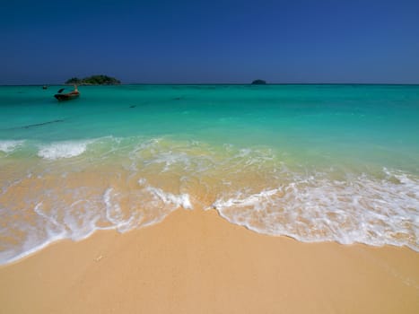 Turquoise sea and yellow sand on a tropical beach