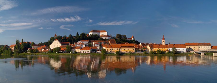 Old city Ptuj with castle and a reflection in river Drava.