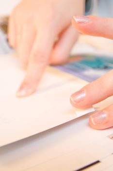 Woman hands sticking images in her photo album. Images can be replaced.