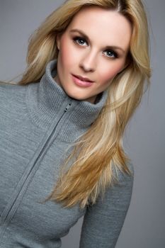 Beautiful blond woman wearing sweater