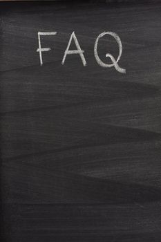 FAQ - frequently asked questions title handritten with white chalk on a blackboard with strong eraser pattern