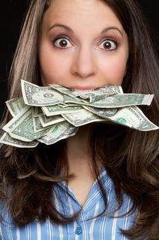 Woman eating money in mouth