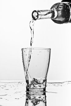 glass of pouring water with reflection (white background)
