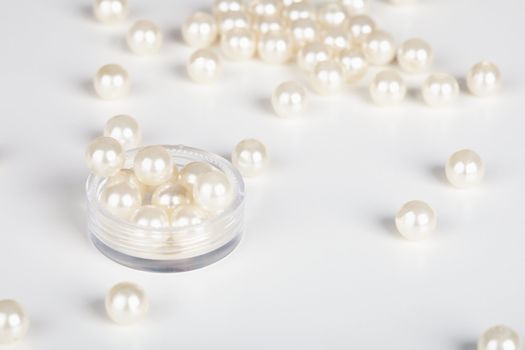 The artificial pearls are scattered light background