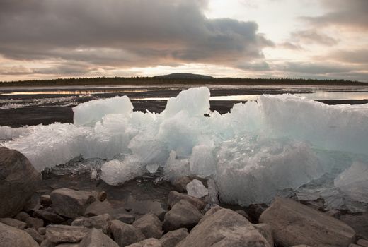 Spring ice thaws on the bank of lake
