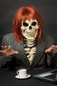 The amusing skeleton with red hair tries to frighten us