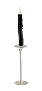 Black candle over an elegant glass candelabrum, over white