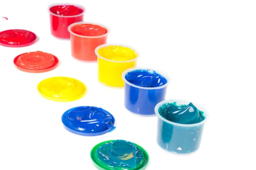 Shot of multicolored cans of paint isolated on white