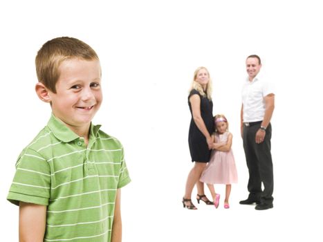 Young boy in front of his family isolated on white background