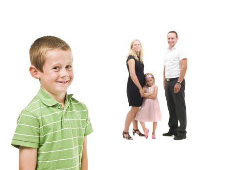 Young boy in front of his family isolated on white background
