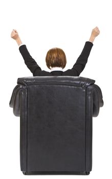 Rear image of a businesswoman sitting in an armchair and expressing satisfaction. 