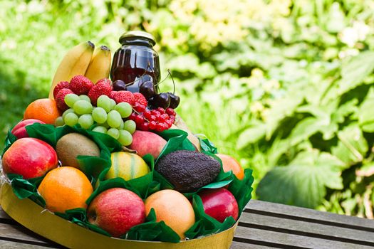 Selection of colorful, fresh, natural looking fruit, made up in a round box as a gift to a sick person