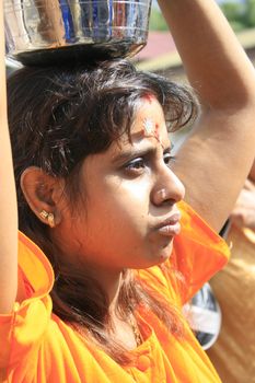 A lady offering milk in Thaipusam celebration in Singapore 2009.