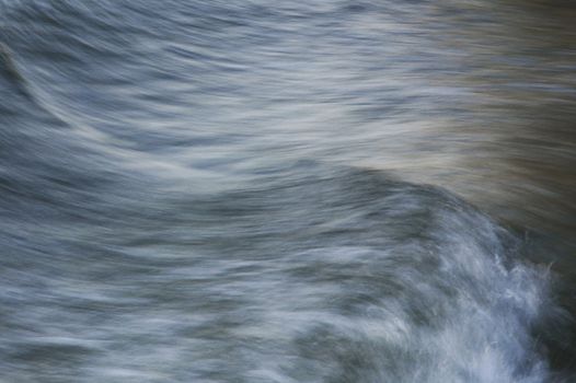 A painterly photo of a wave. Move is captured with long exposure.