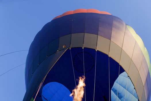 Hot air balloon flying fast. Burner is throwing flames.