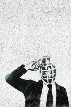 grenade head man black and white grafitti on the wall