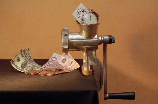 Conceptual still life with mincing machine, money and clock (horizontal image)