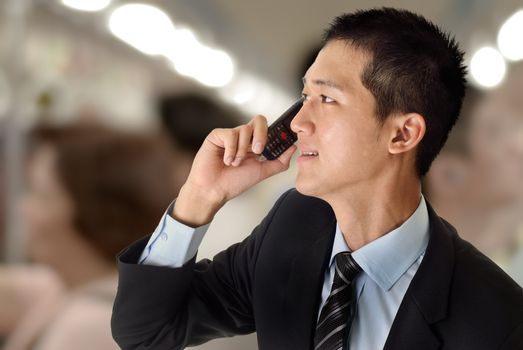 Young business man use cellphone in train.