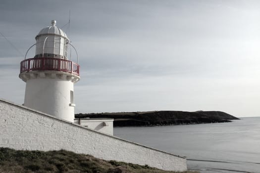 lighthouse during a sunny day on the rocks in youghal county cork ireland