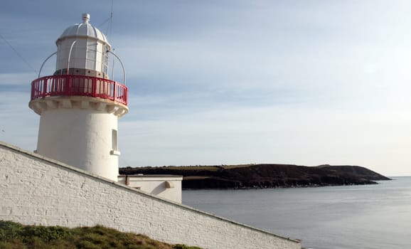 lighthouse during a sunny day on the rocks in youghal county cork ireland