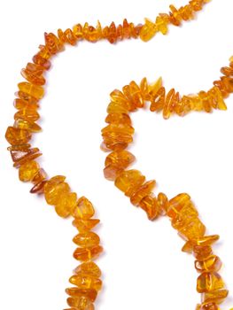 amber bead on off- white background close up