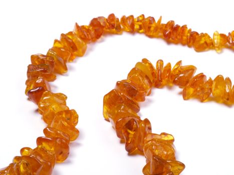 amber bead on off- white background close up