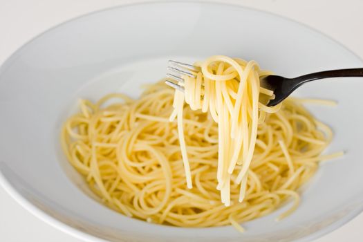 fork over a plate with spaghetti