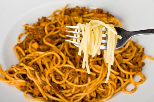 fork over a plate with spaghetti