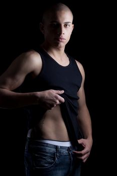A good looking, muscular built, man on a black background.