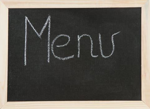 Black chalk board with wooden framed surround with the word Menu.
