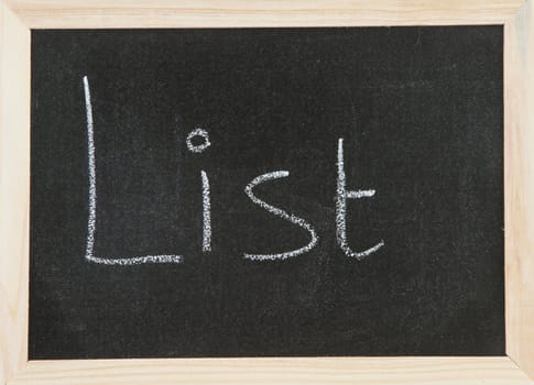 Black chalk board with wooden framed surround with the word List.