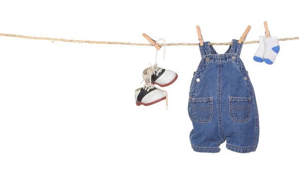 Cute Baby Boy Clothes Hanging on a Rope With Copyspace