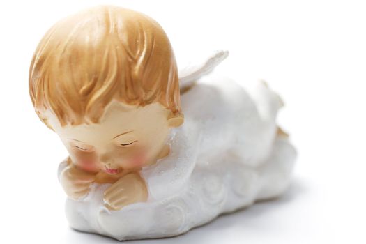 sleeping christmas angel with soft focus on white background