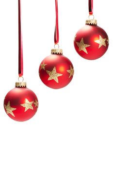 three hanging dull red christmas balls with golden glitter stars on white background