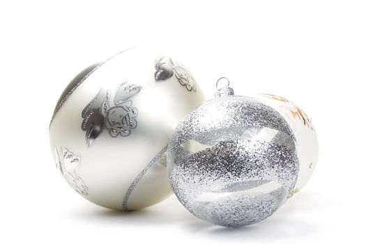 three different white and silver christmas balls on white background