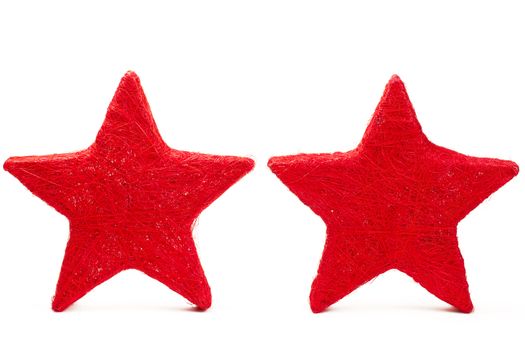 two red thread stars standing on white background