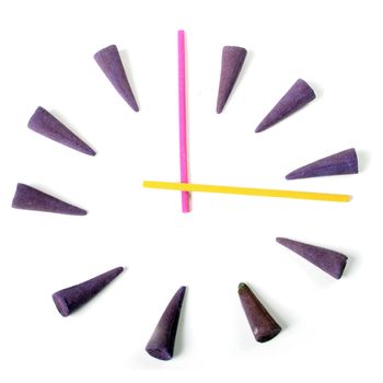 clock by aroma sticks isolated over white