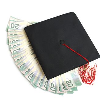 A grad hat with spread out money for an education or tuition fee concept.