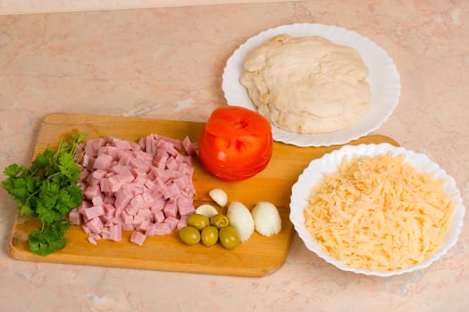 pizza ingredients - parsley, ham, olive, onion, garlic, cheese and pastry