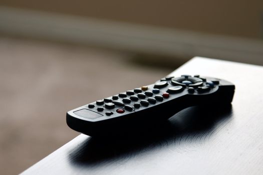 A remote control sitting on table in a living room.
